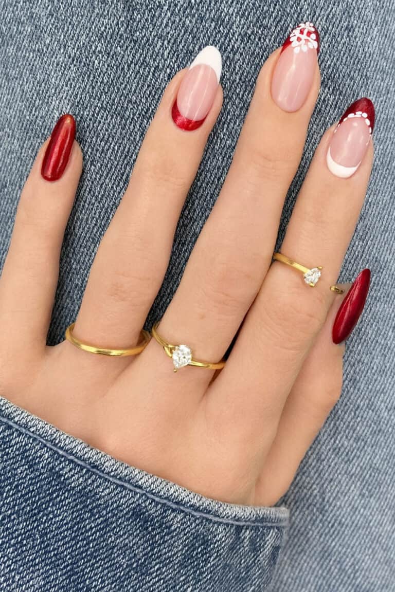 Classic red and nude combination with sheer French tips and a subtle snowflake accent.