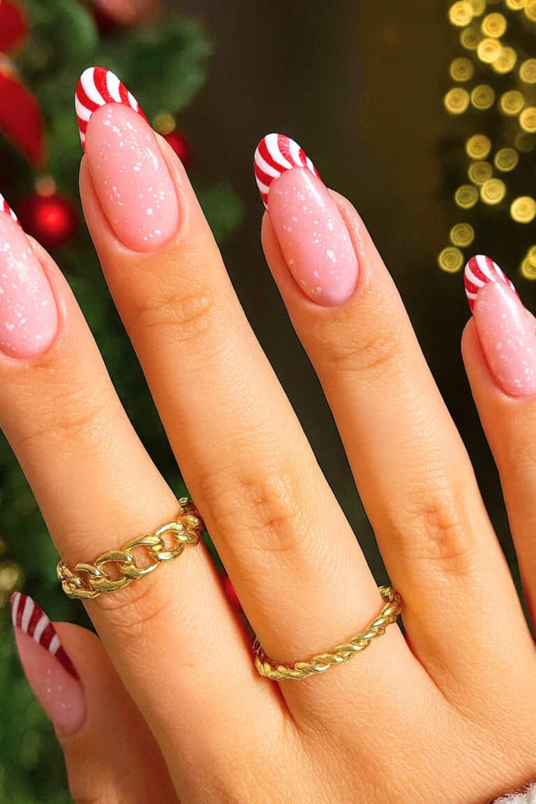 Soft pink speckled base with red and white candy cane swirl design on the tips.
