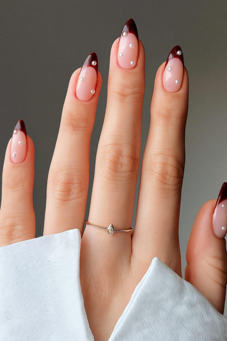 Soft pink base with deep red tips and tiny pearl details
