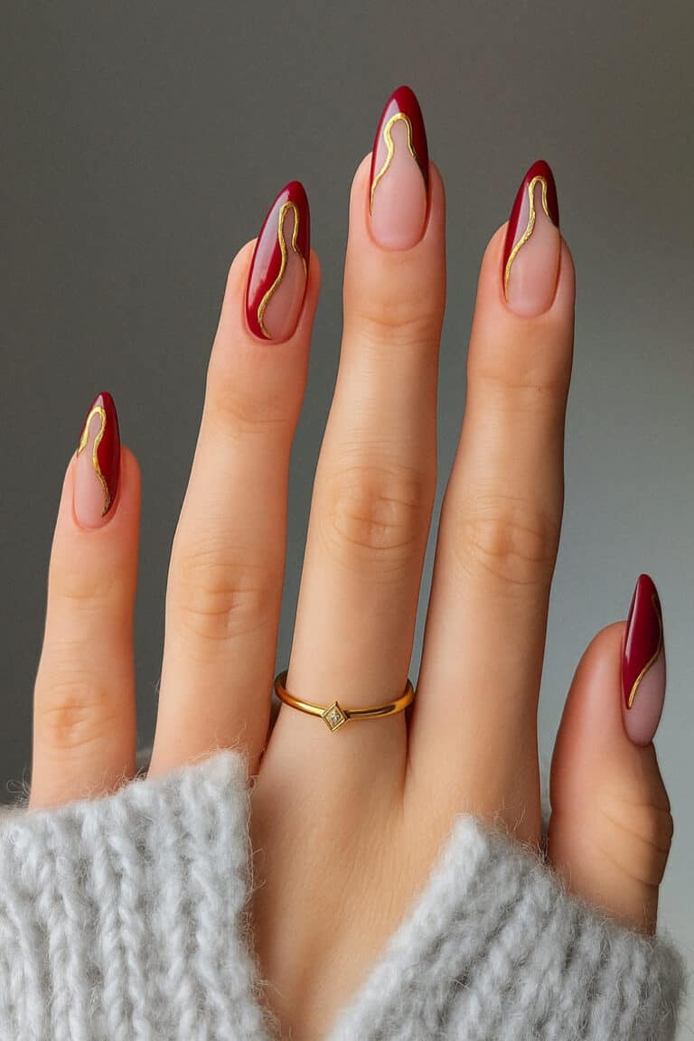 Deep red and gold wavy outline French tips with negative space