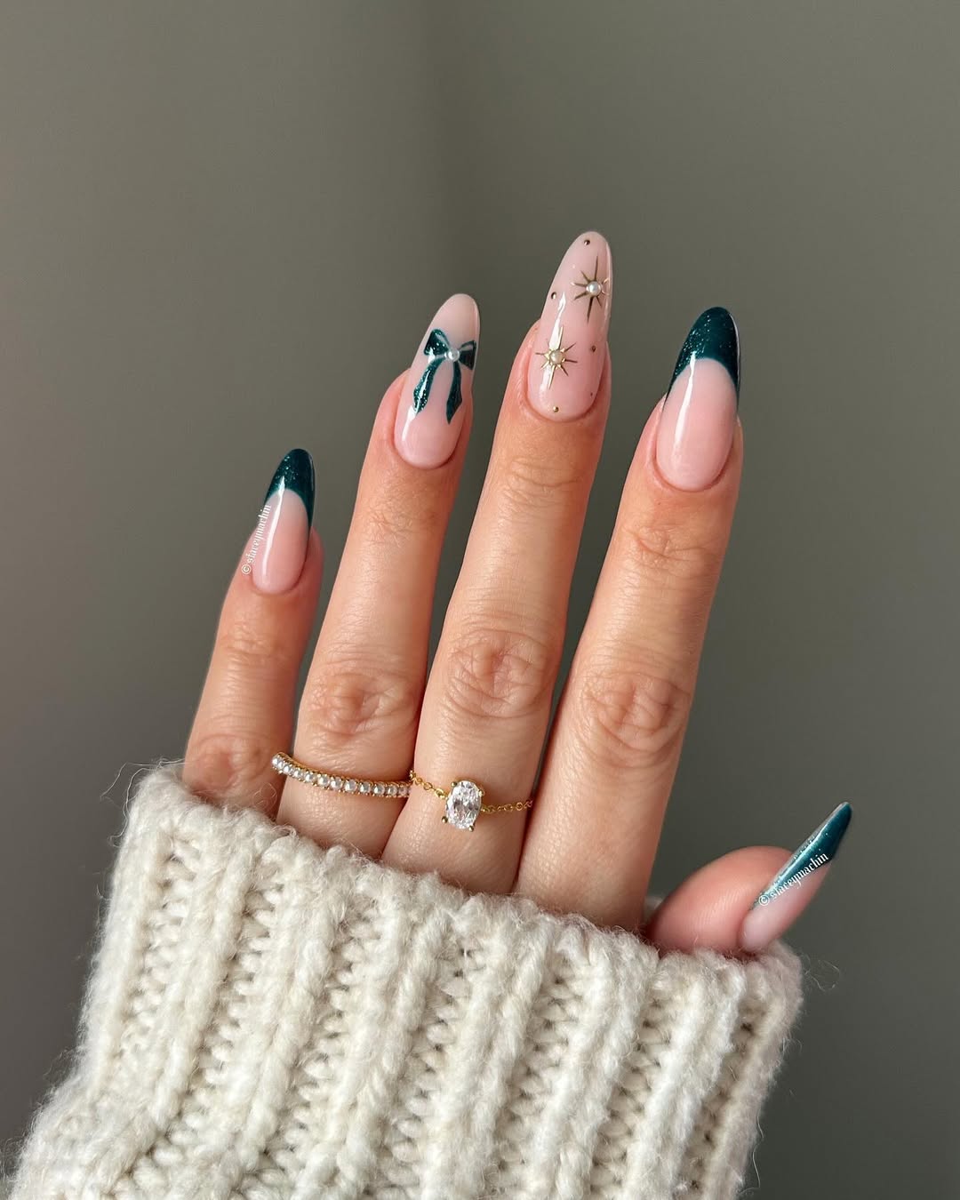 Emerald green French tips with star accents and ribbon designs.