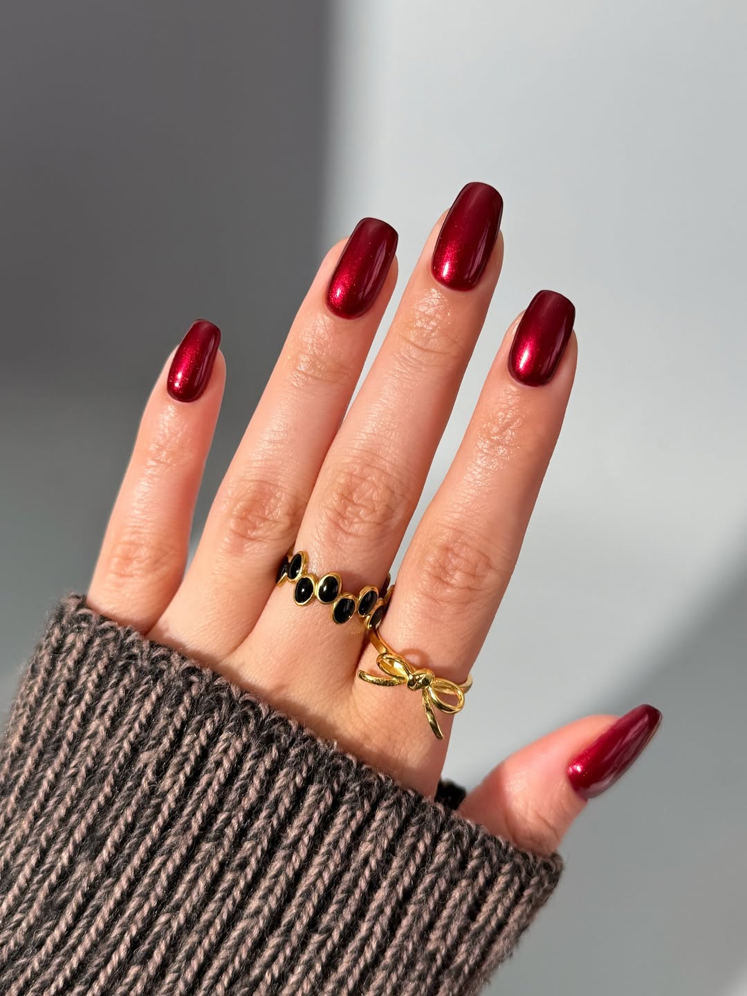 Rich cherry red polish with a subtle metallic sheen.