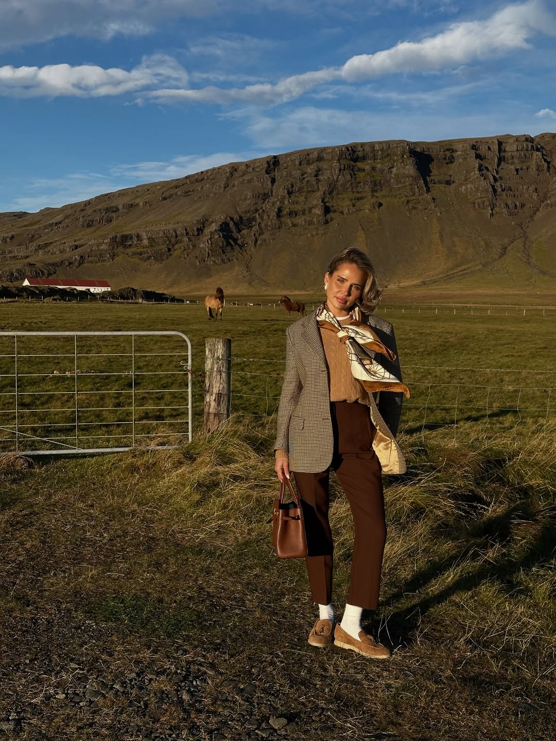 Checked blazer, camel vest, brown trousers, and loafers