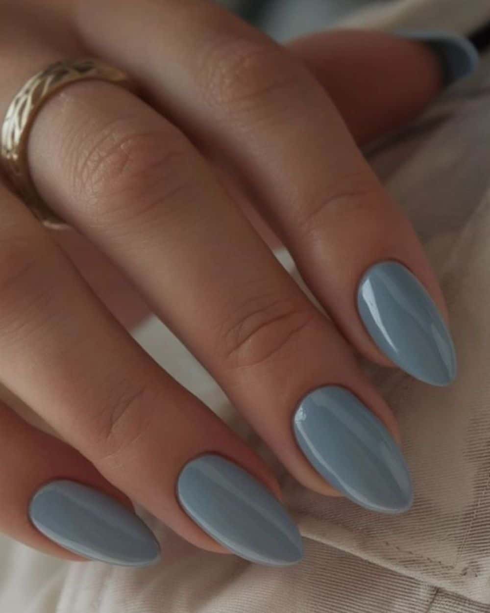 A set of nails featuring a gradient of faded blue shades