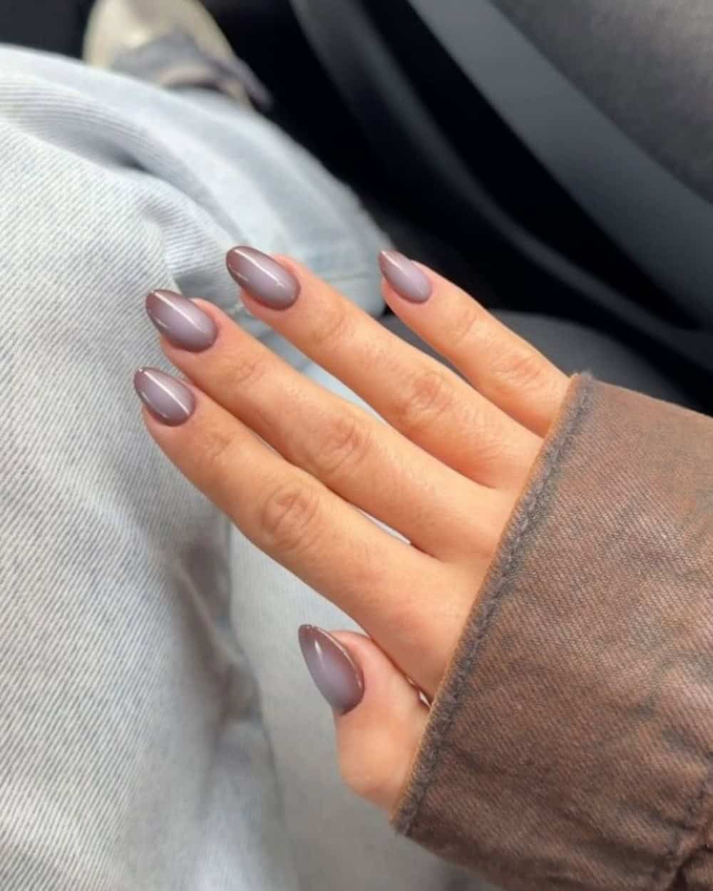 A moody mauve nail with an aura effect design