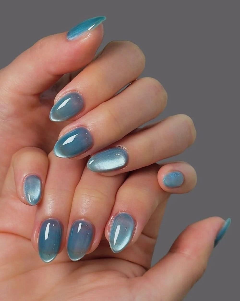 Faded blue nails on short, natural-shaped nails
