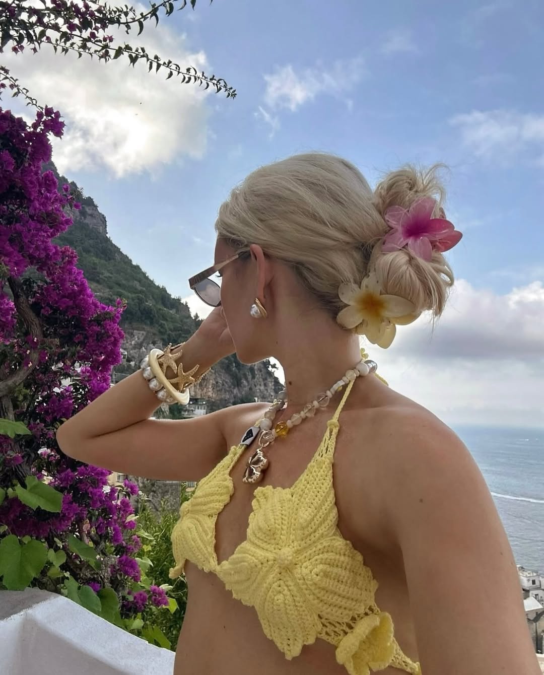 A slightly undone low bun with flowers tucked in.
