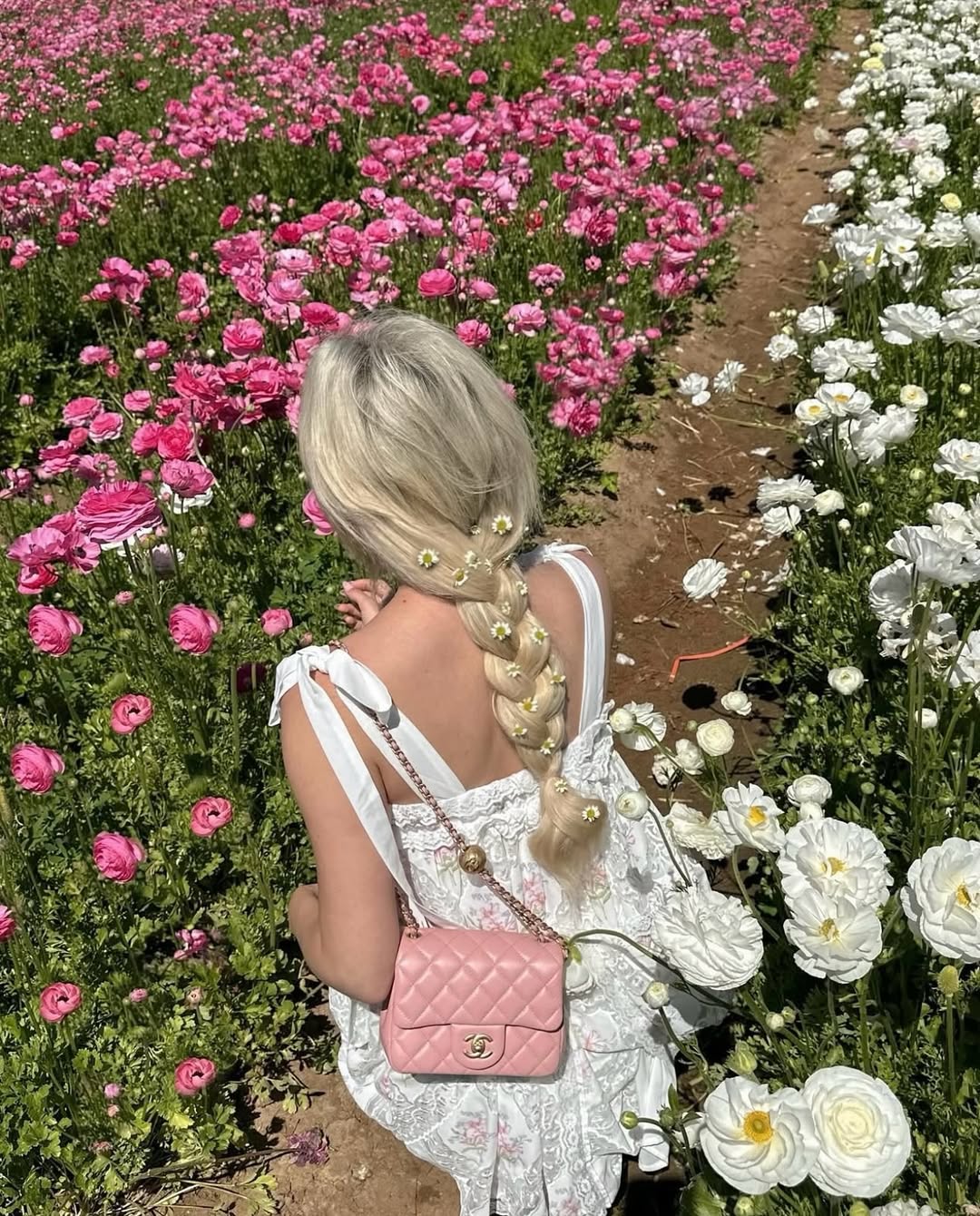 A braid decorated with small flowers, evoking a garden scene.