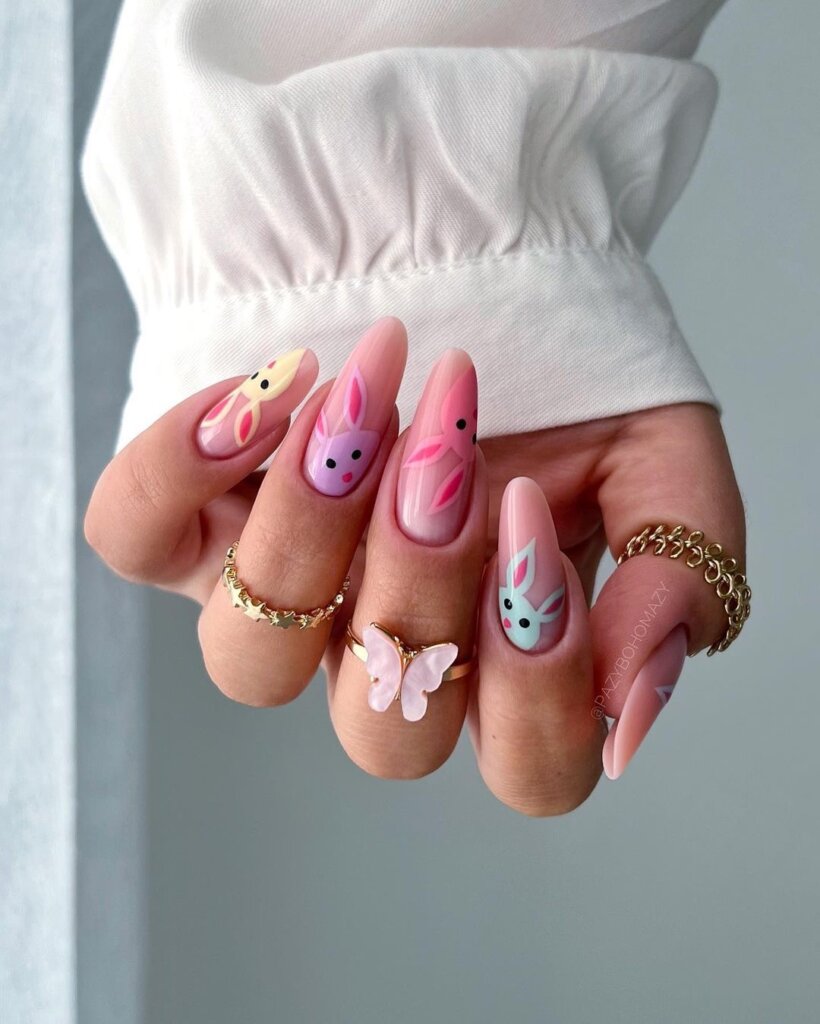 Soft pink nails with sweet motifs and a cozy, whimsical feel.
