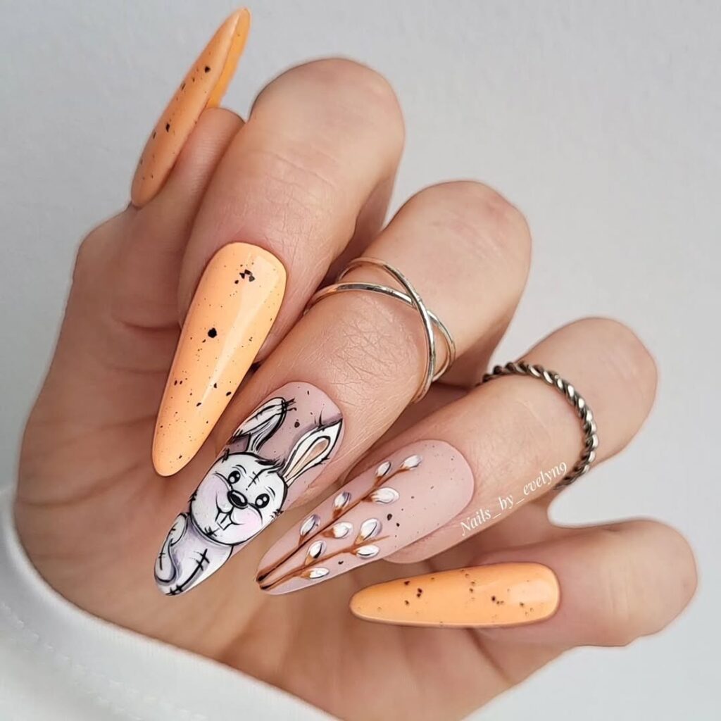 Easter-themed nails featuring carrots, speckles, and a bunny illustration.