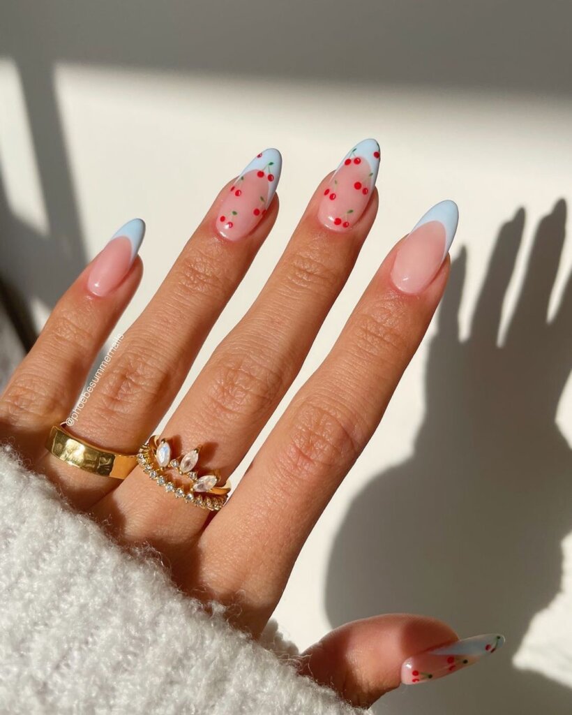 Pale blue French tips with small red cherry blossom details.