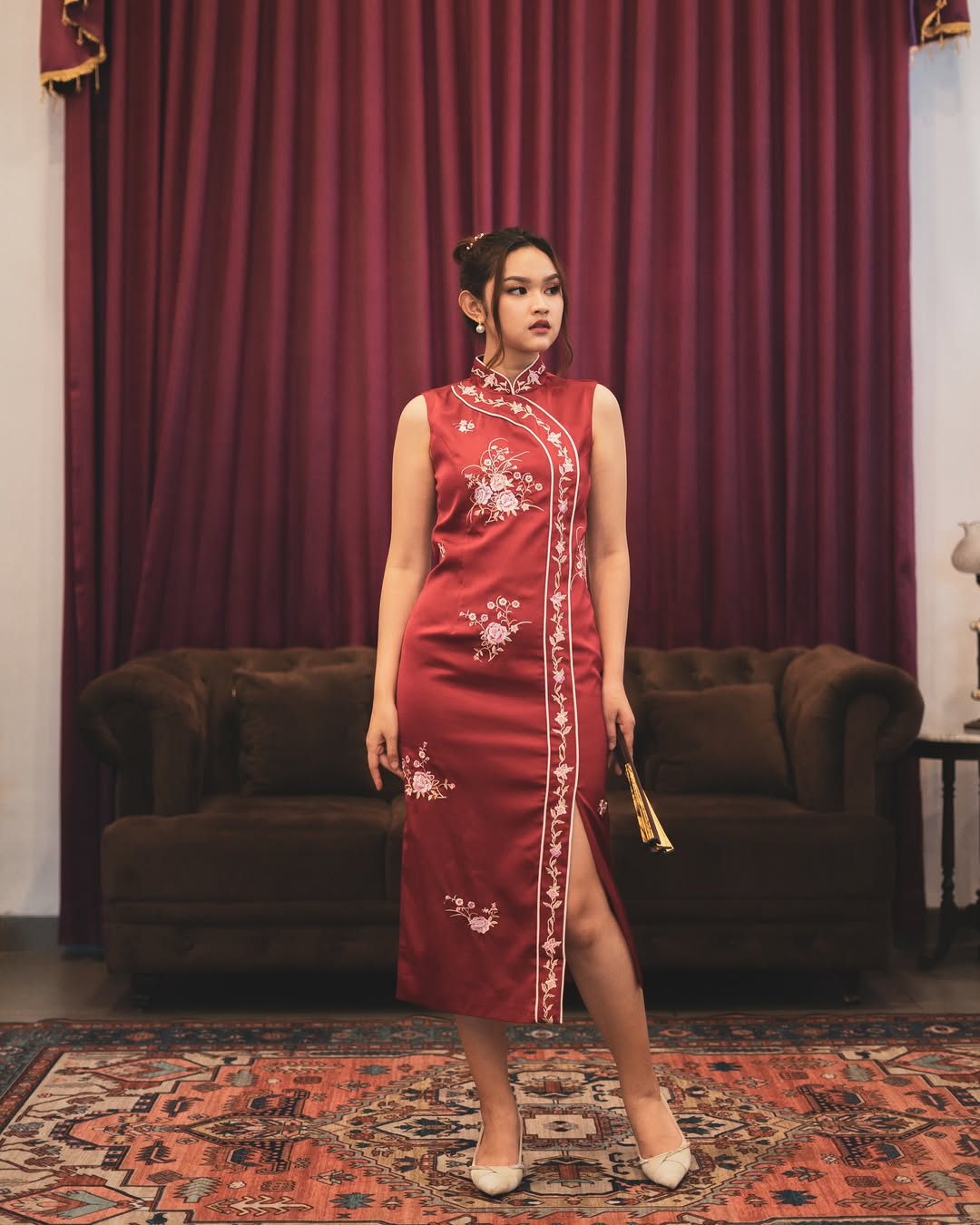 A classic red dress updated with a modern, clean silhouette for a timeless Chinese New Year look.