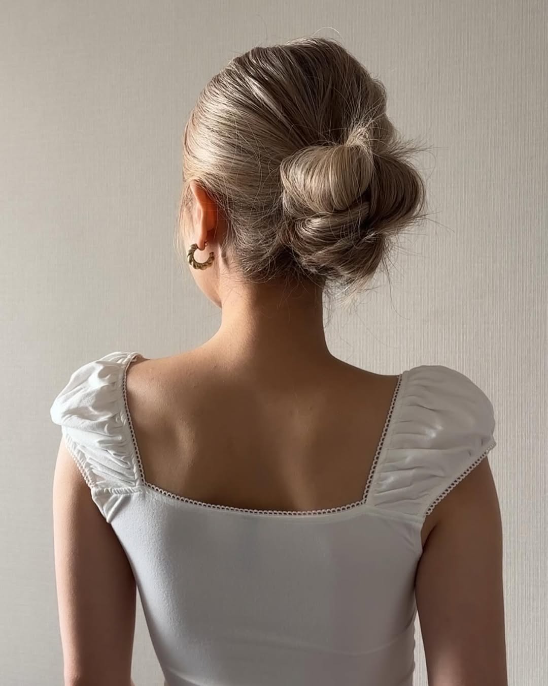 A very smooth and sleek low bun.