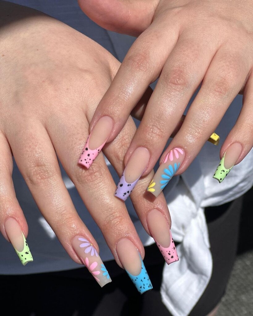 Easter nails with bold pastel color-blocked tips and speckled details.