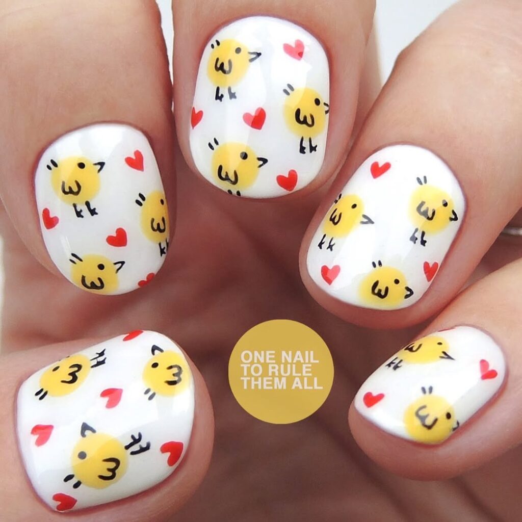 Nails with tiny characters and pops of red for a playful Easter look.