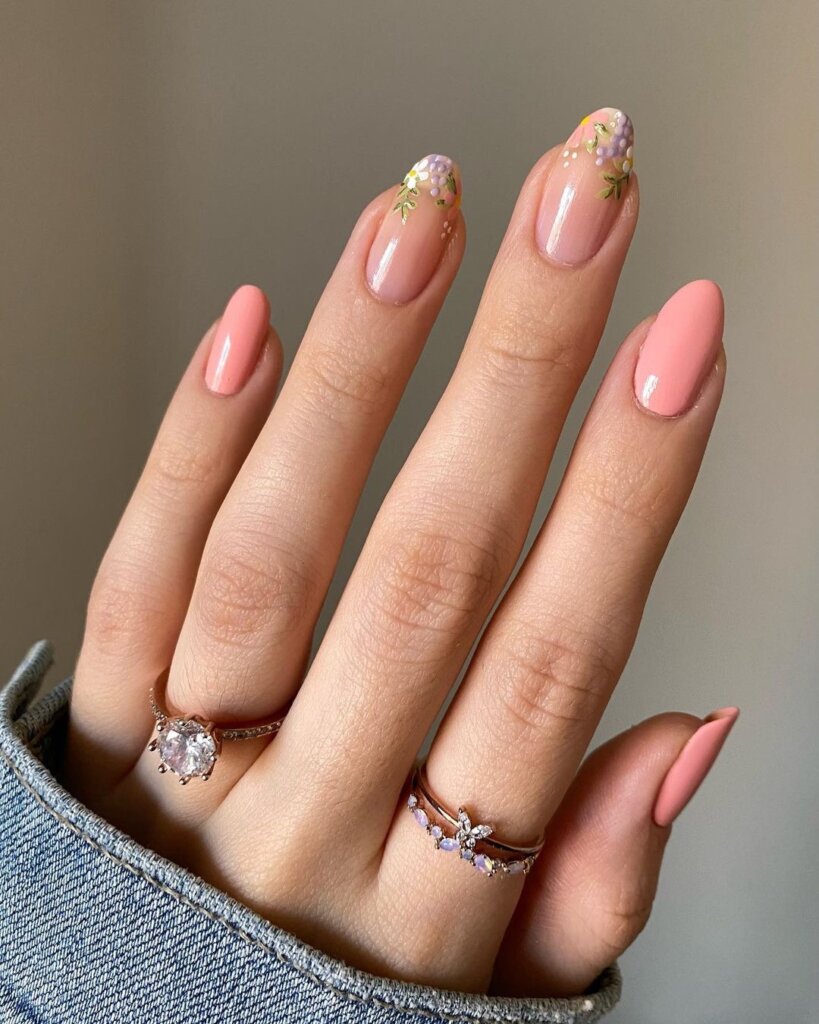Soft peachy-pink nails with tiny floral accents.