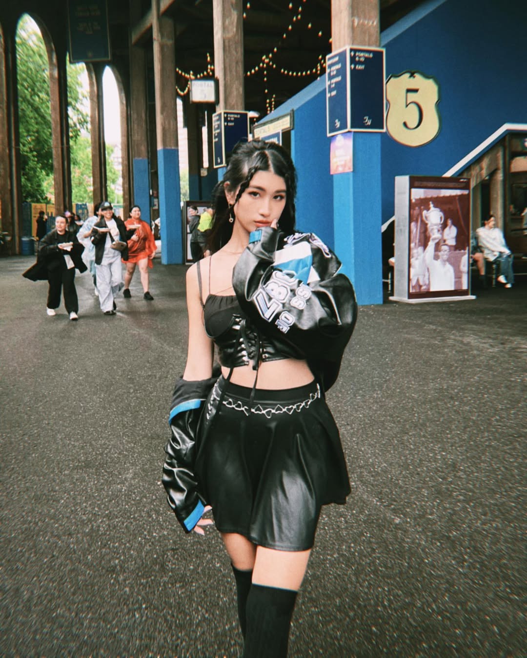 A bold and cool festival outfit with black leather, chain details, and a cropped silhouette, exuding main-character confidence.