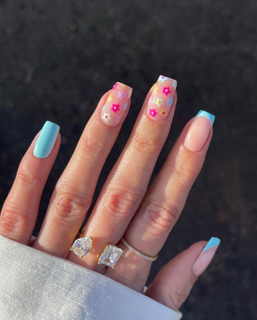 Sheer nails with scattered tiny pastel floral designs.