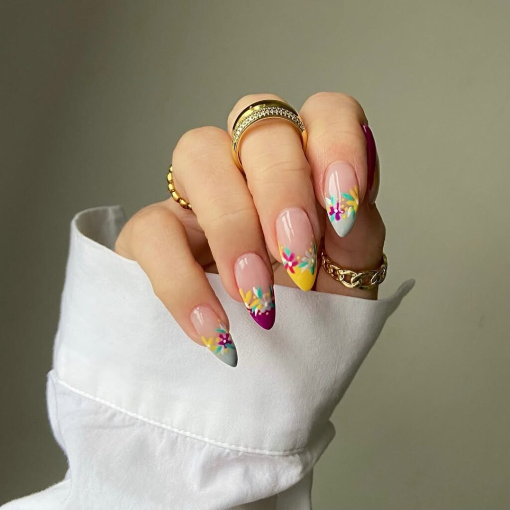 Muted pastel nails with tiny floral accents for a refined look.