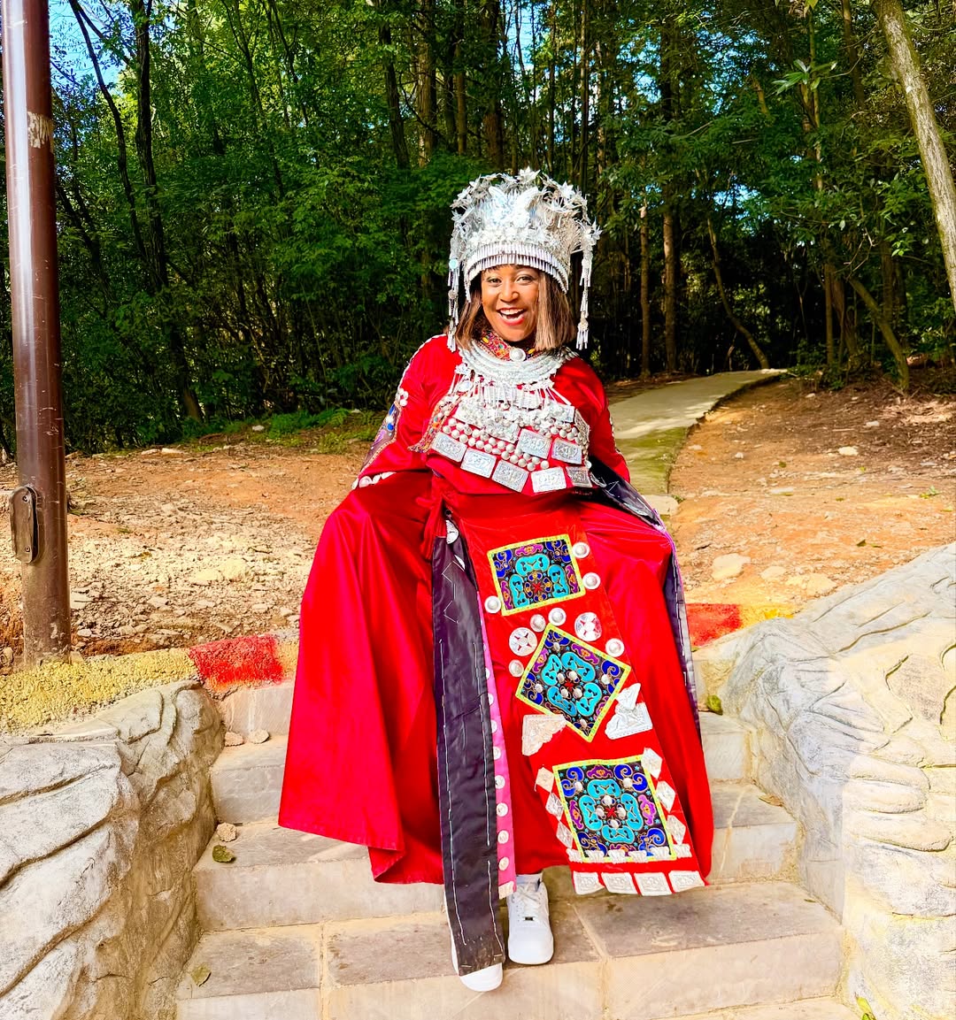 An outfit featuring rich red tones and intricate silver detailing, inspired by traditional heritage and radiating joy.