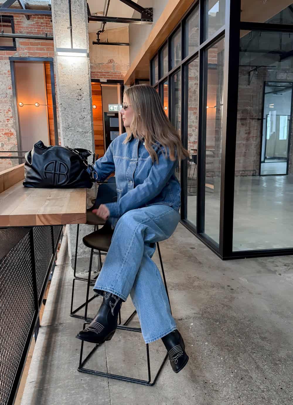 Woman wearing monochromatic denim, Western boots