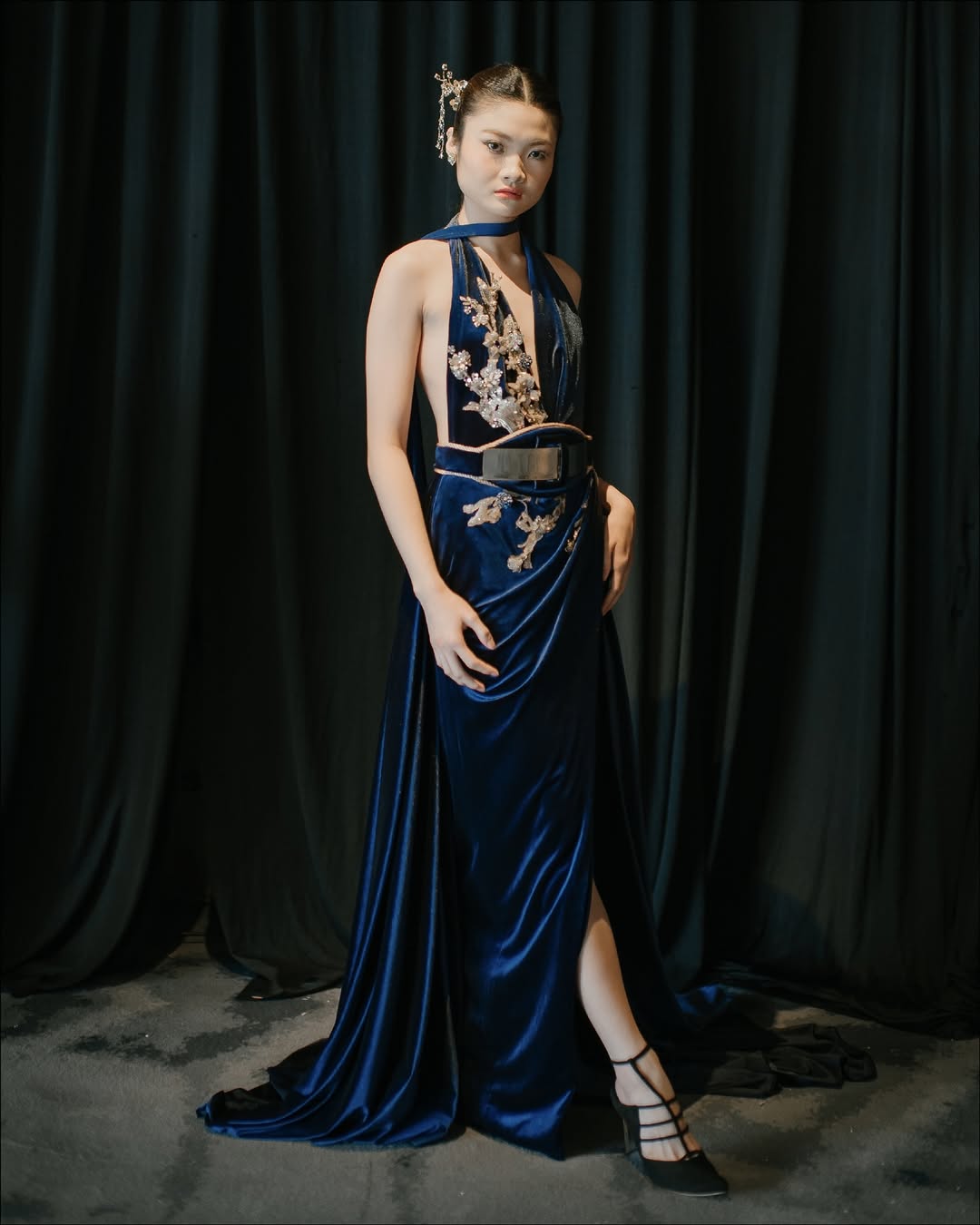 A sophisticated midnight blue dress that offers an elegant alternative to traditional red for Chinese New Year.