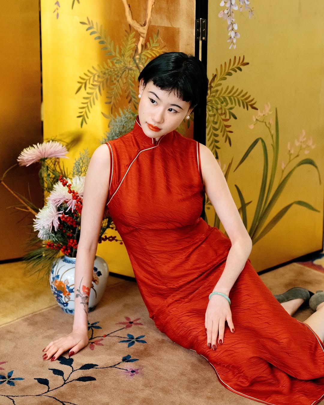 A minimalist red dress that makes a strong visual statement through its clean design and vibrant color.