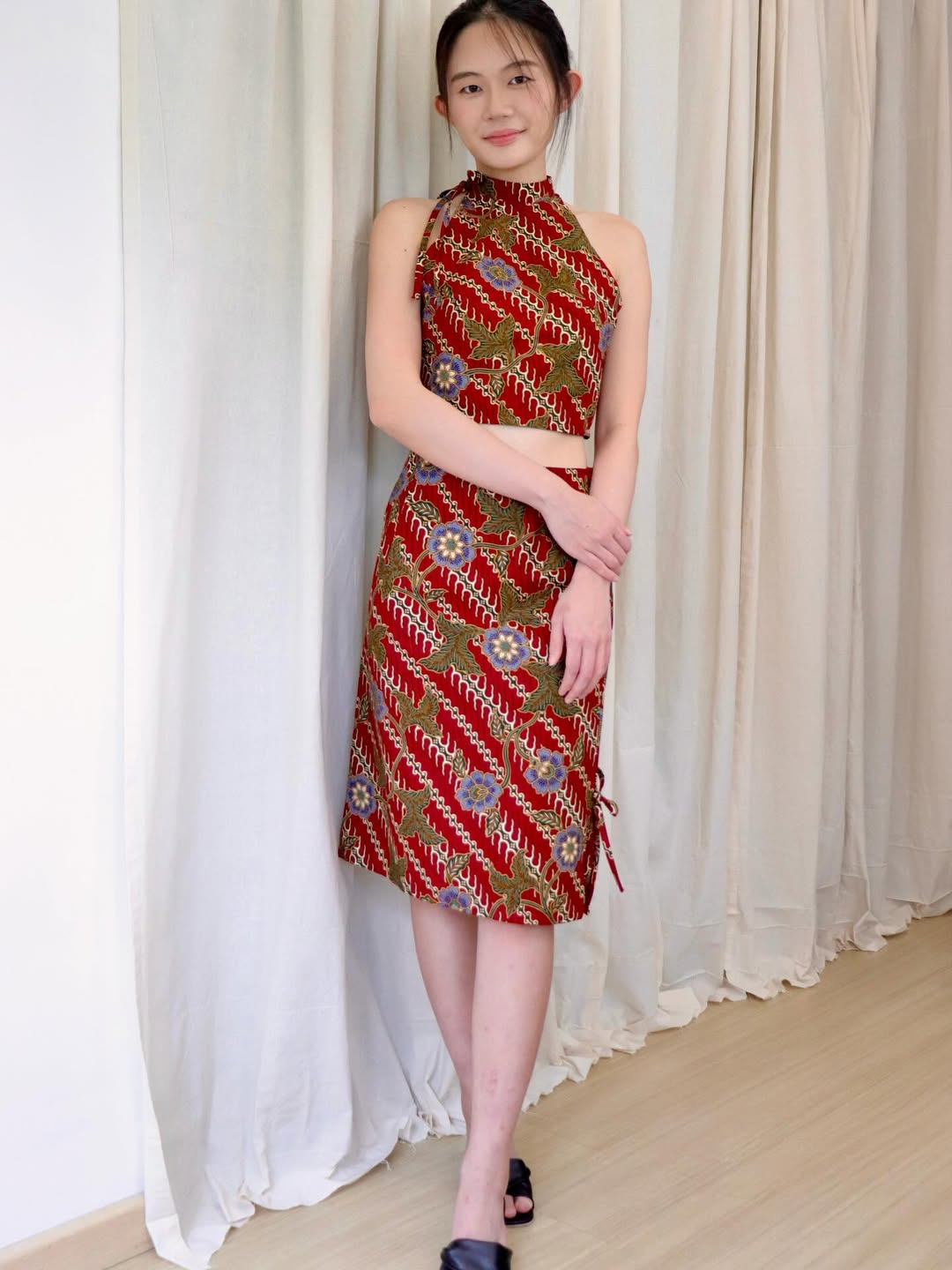 A dress with a traditional batik print and a modern cropped silhouette, offering a stylish and comfortable festive look.