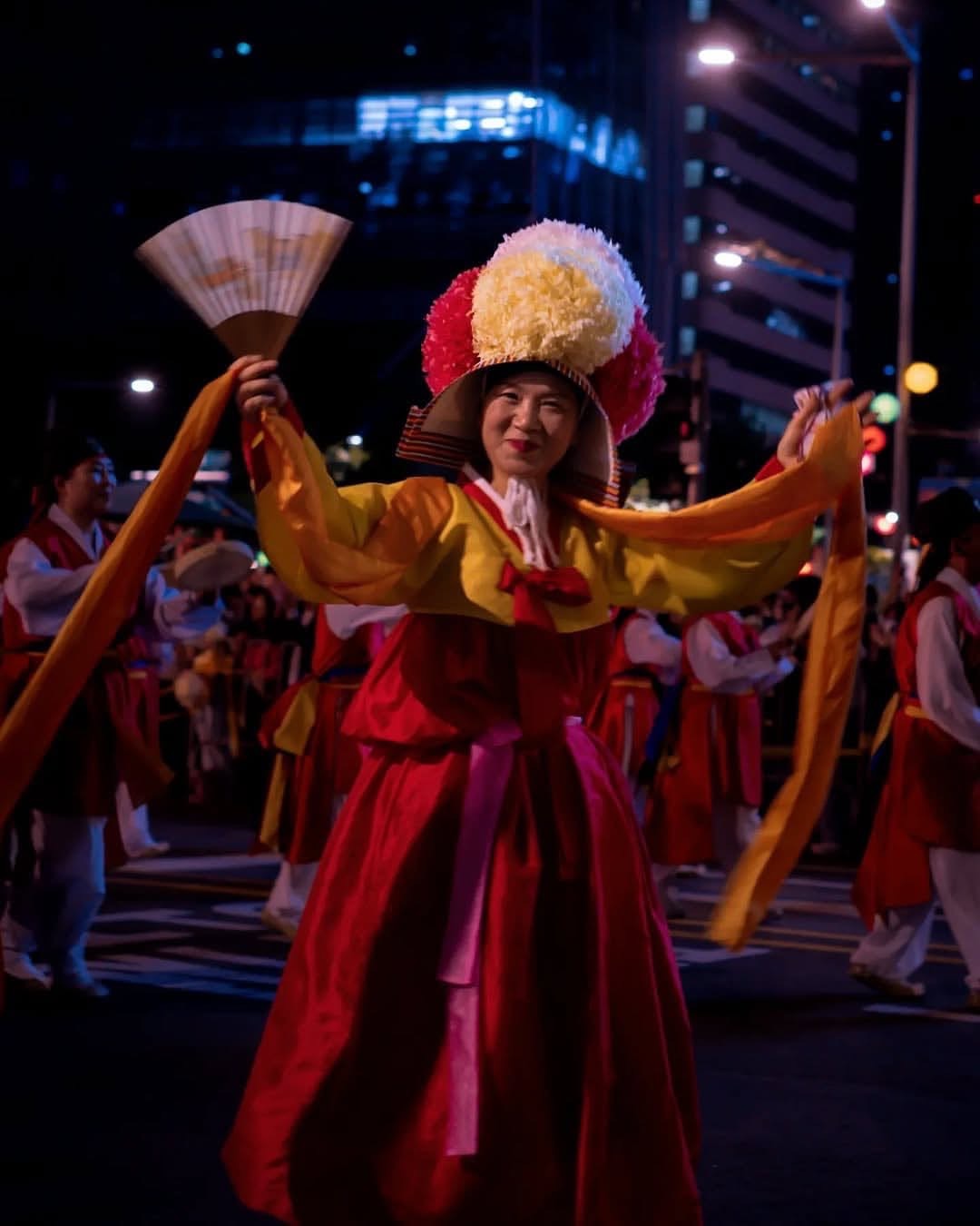 A flowing outfit with soft fabrics, complemented by the warm glow of lantern light, creating a cinematic and elegant festival look.