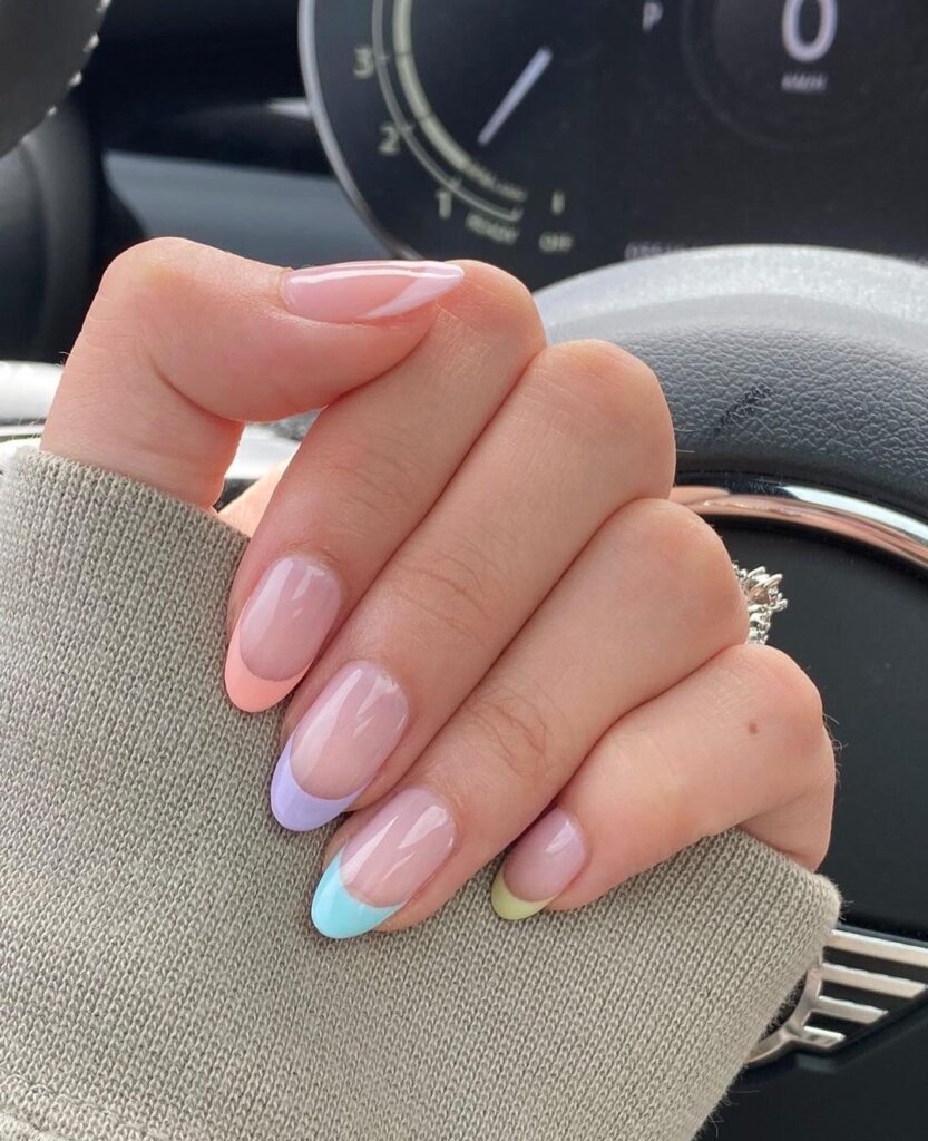 Soft pastel French tips, each with a slightly different shade.