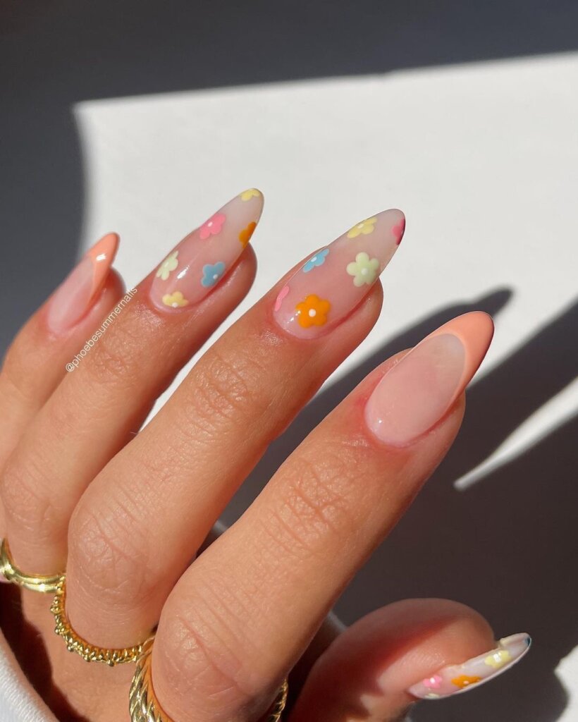 Sheer nails with scattered soft pastel floral designs.