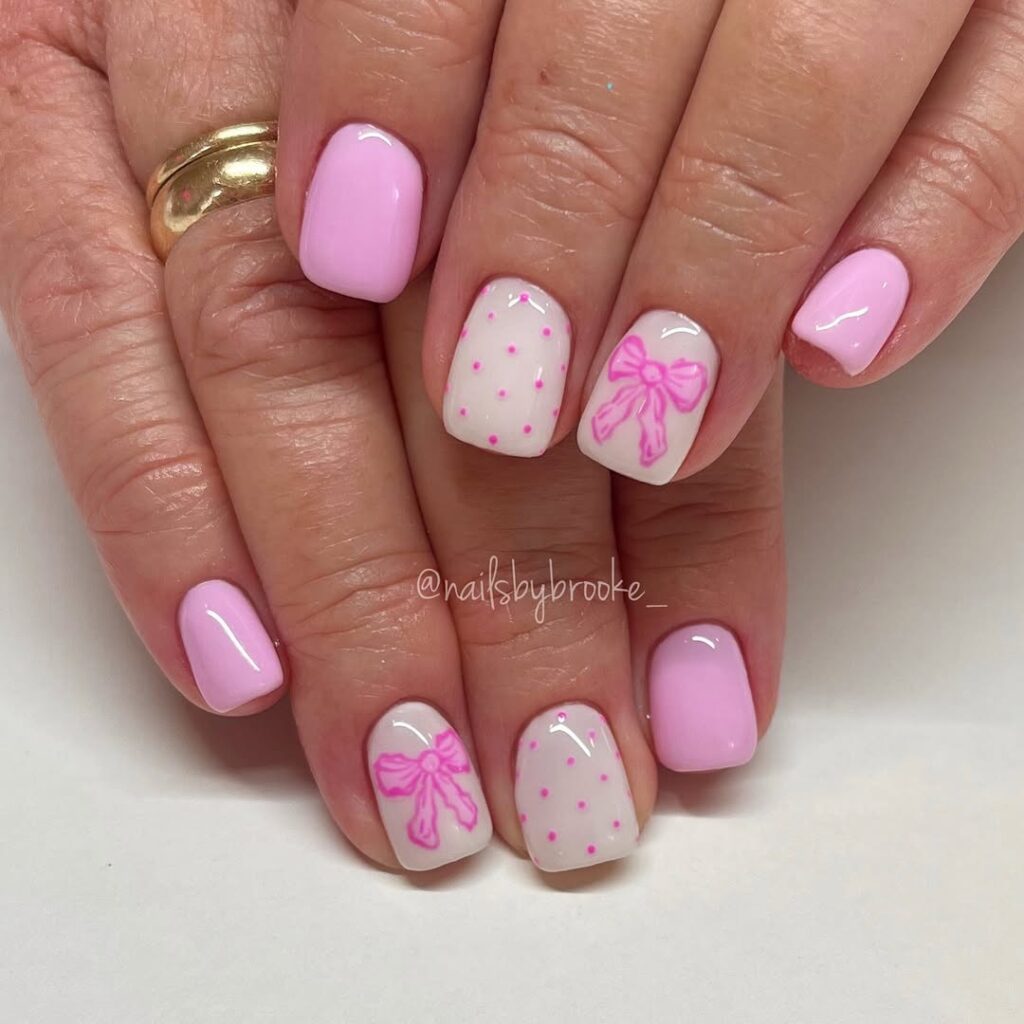 Soft pink nails with polka dots and tiny bow details for Easter.