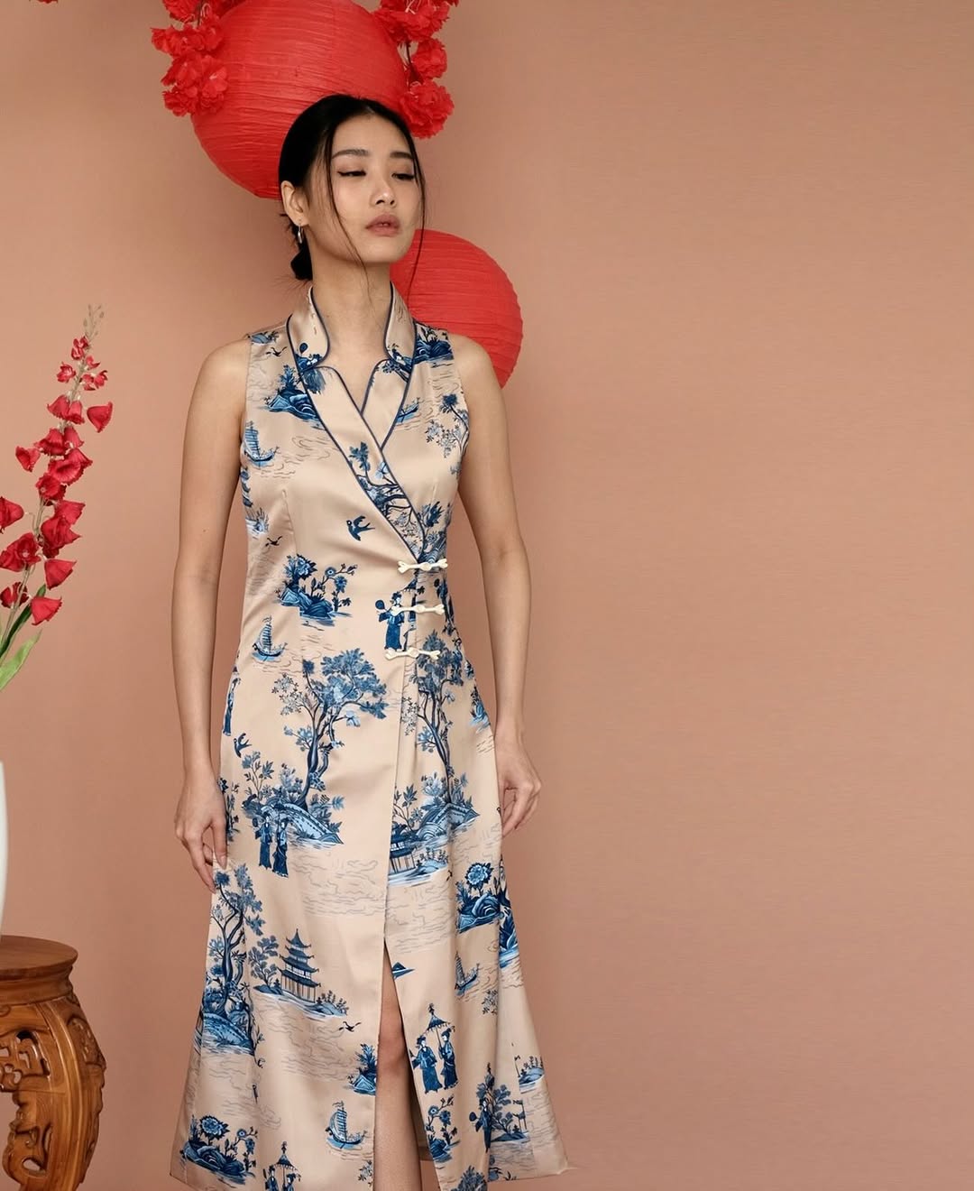 A dress featuring a blue and ivory toile print, inspired by porcelain, with a modern, sleeveless design.