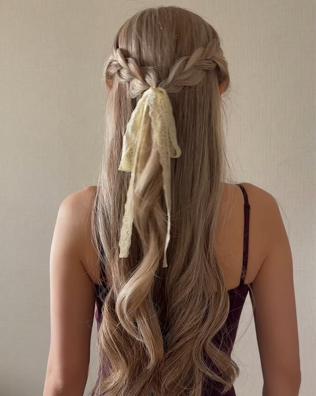 Loose waves styled into a romantic half-up twist.