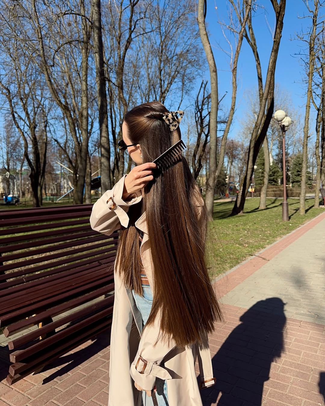 A polished half-up hairstyle secured with a minimalist clip.