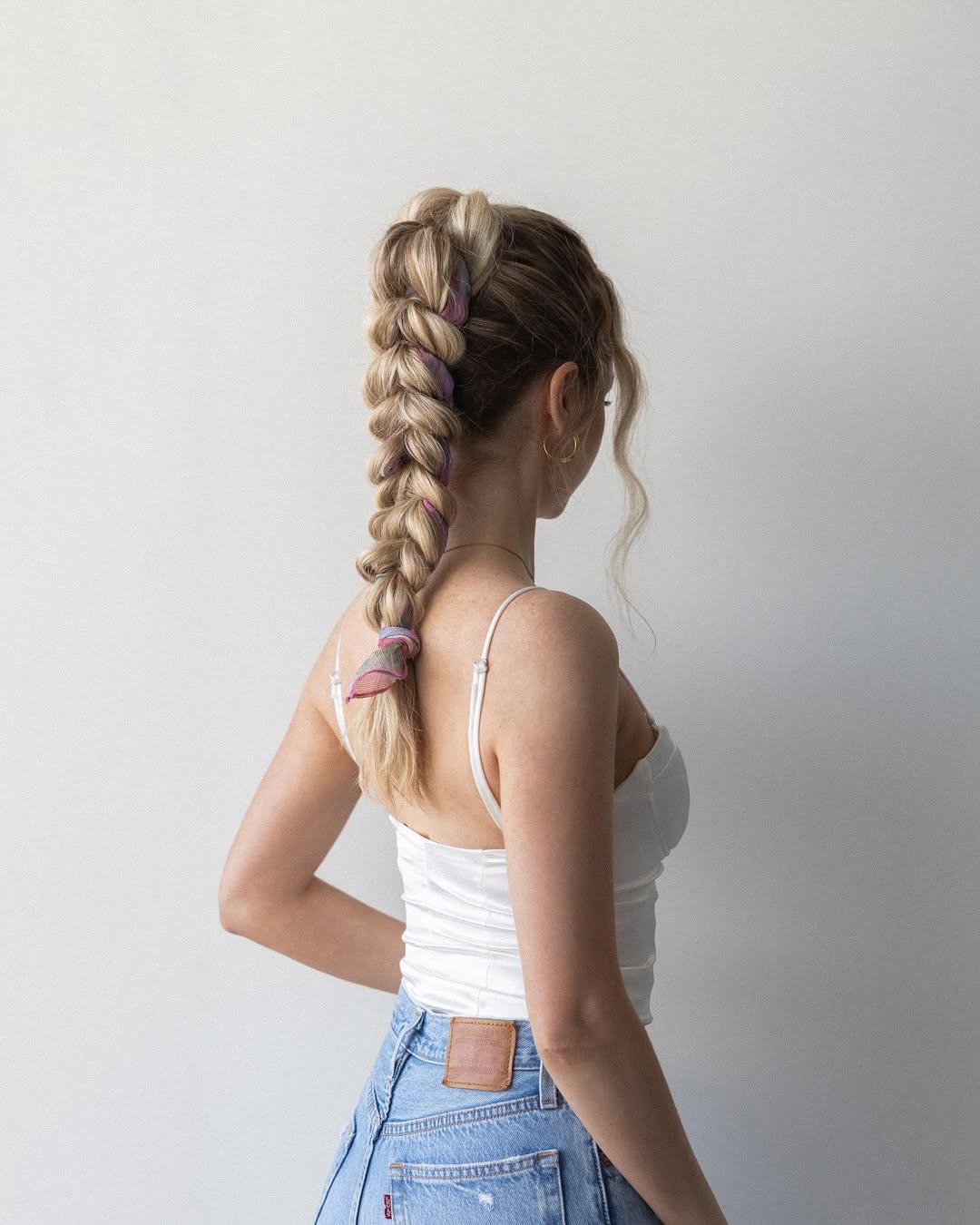 A woman with a soft braided ponytail