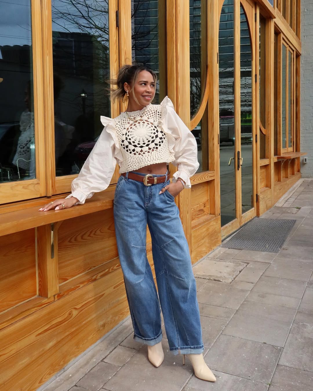 A ribbed green dress styled with crisp sneakers and a light white layer, offering a calm and refined minimalist look.