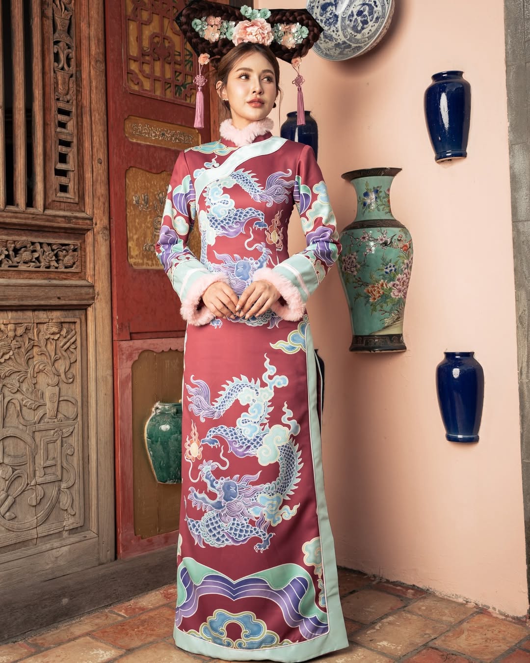 A woman in a soft pastel-colored dress featuring traditional Chinese motifs, offering a gentle approach to New Year fashion.