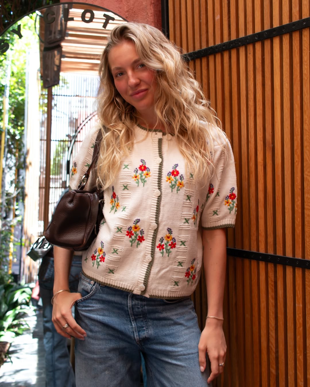 A woman in a flowy yellow sundress with spaghetti straps.