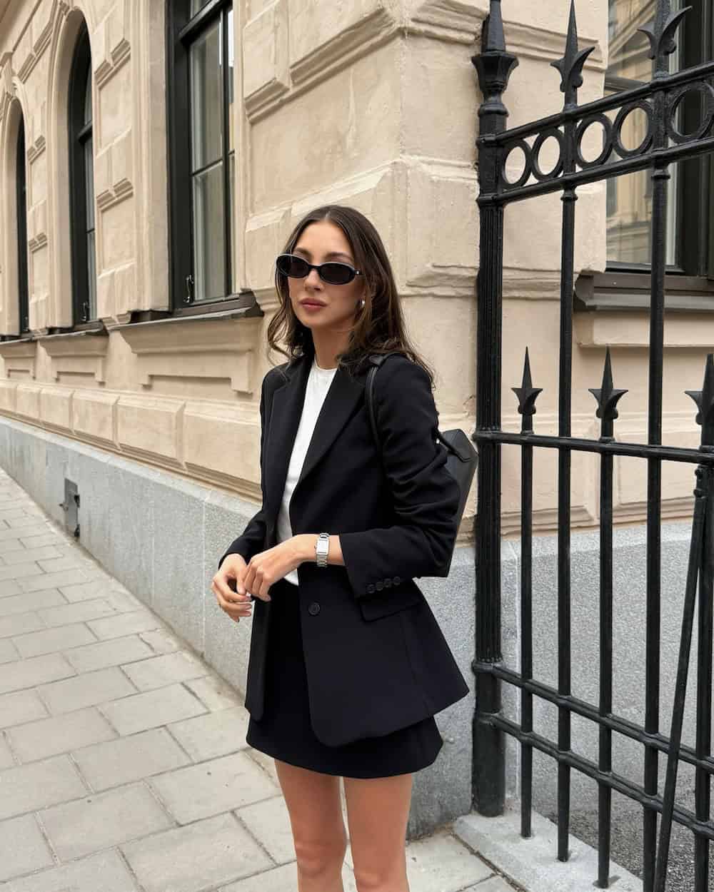 Woman wearing a mini skirt, blazer, and heels