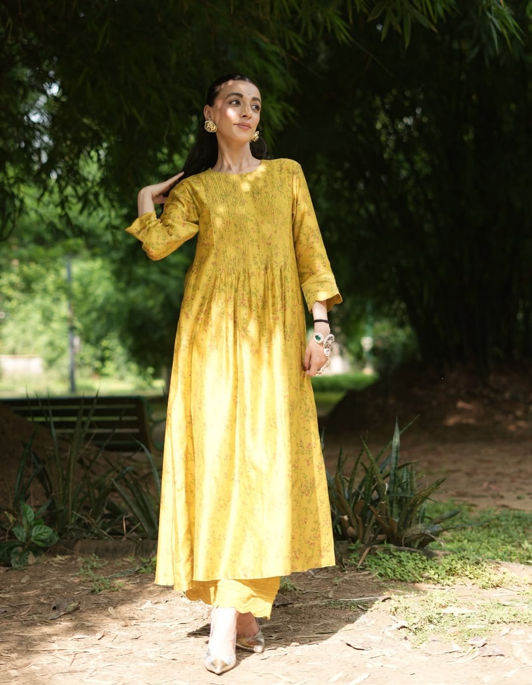 A yellow embroidered dress with soft gathers and delicate detailing, offering a bright and joyful appearance.