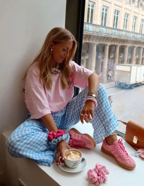 Woman in pink gingham and tee with pink sneakers in Paris