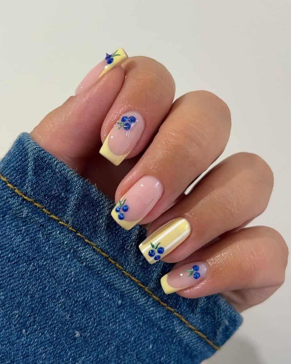 Lemon yellow striped nails with blueberry nail art