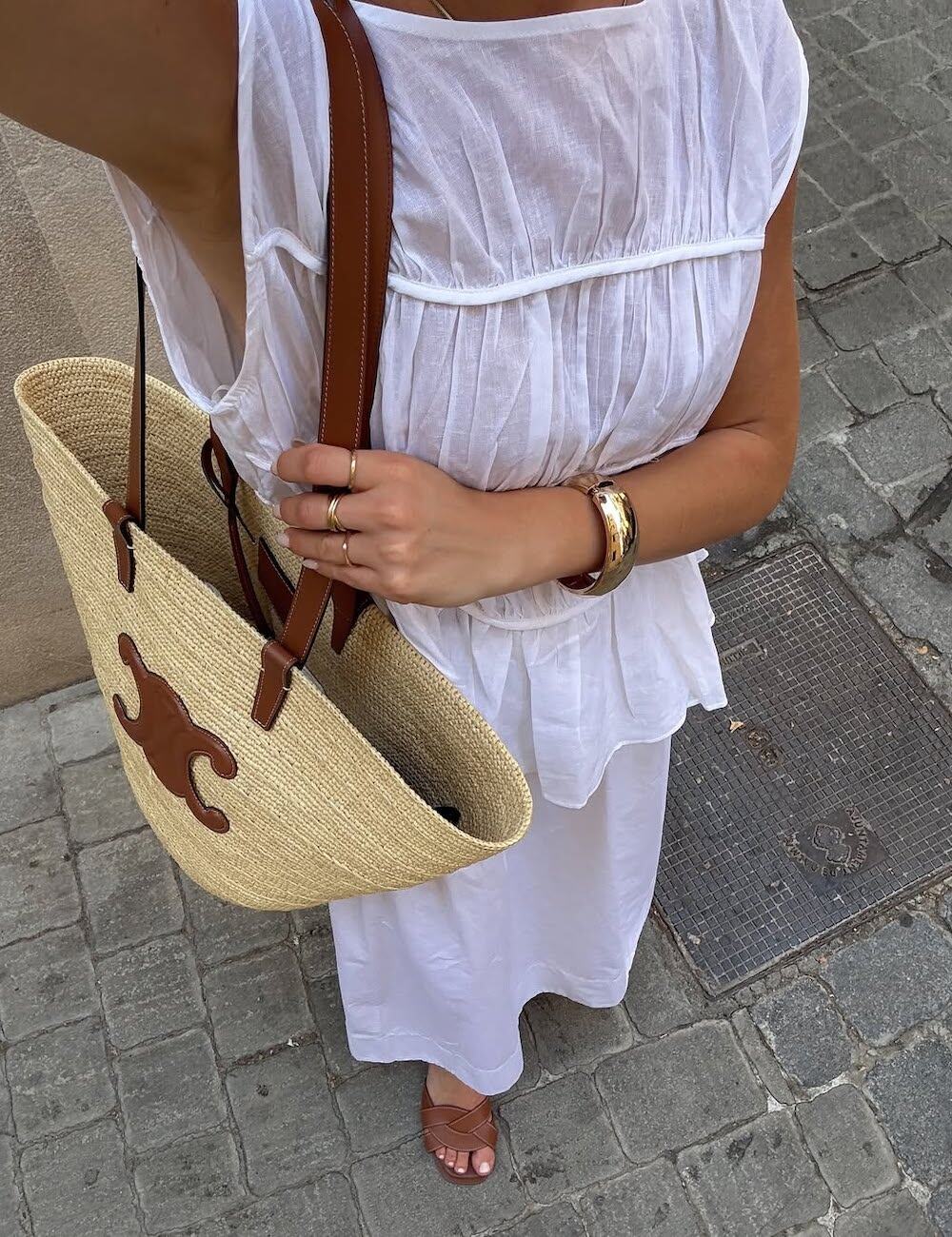 Woman wearing a white midi skirt and tank top
