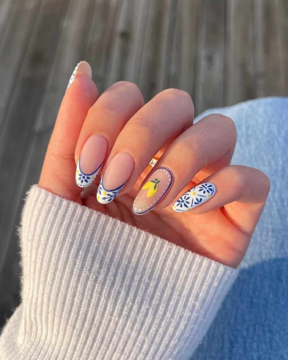 Blue and white patterned nails with lemon art