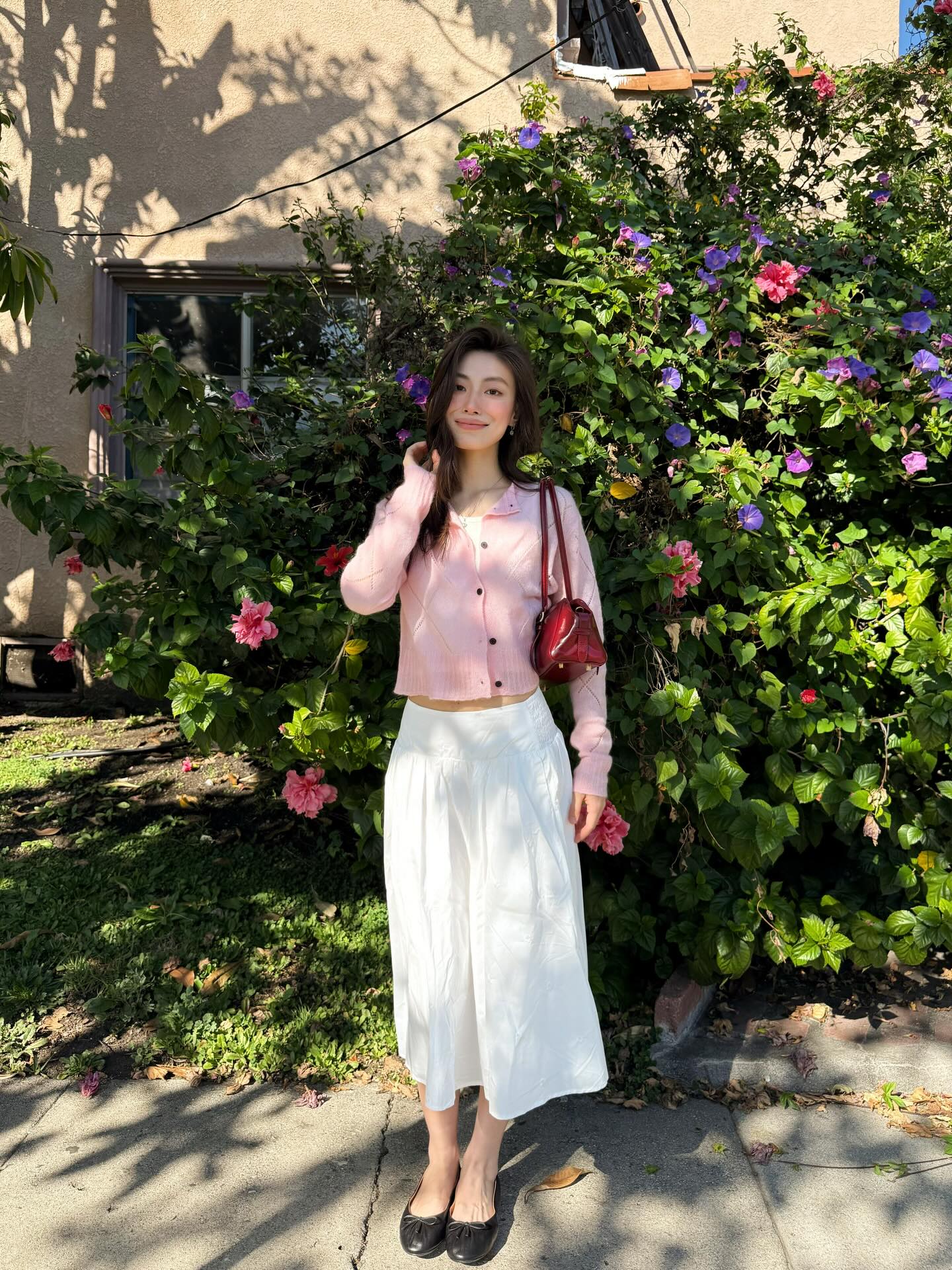Pink cardigan with a white midi skirt