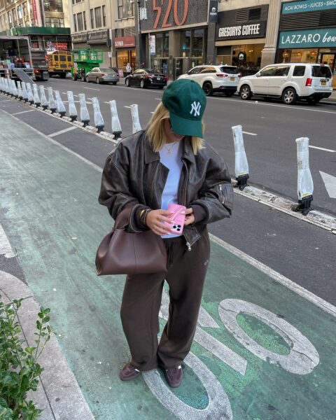 Cocoa flight jacket, blue top, and espresso slacks.