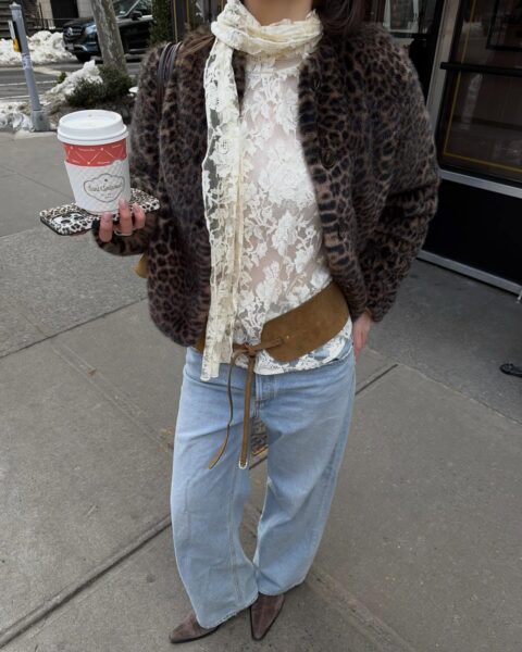 Leopard print jacket over lace, wide-leg jeans, and suede belt.
