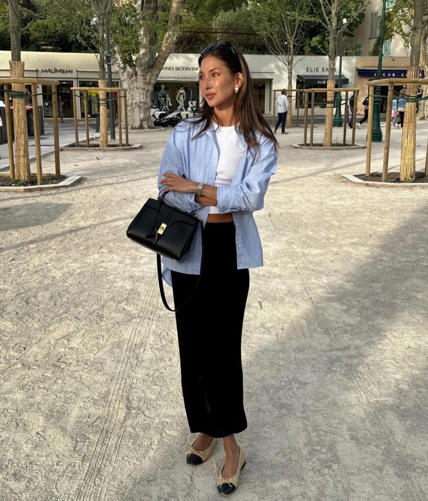 Blue button-down shirt paired with a black maxi skirt