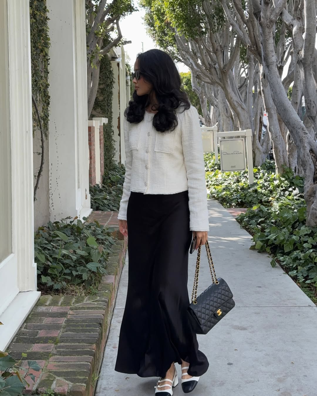 White jacket with a black satin maxi skirt